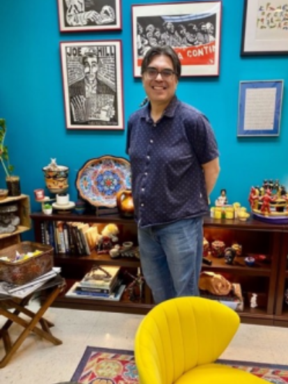 Jose Ochoa, President and CEO of the National Mexican Museum of Art, in his colorful office filled with Mexican Art